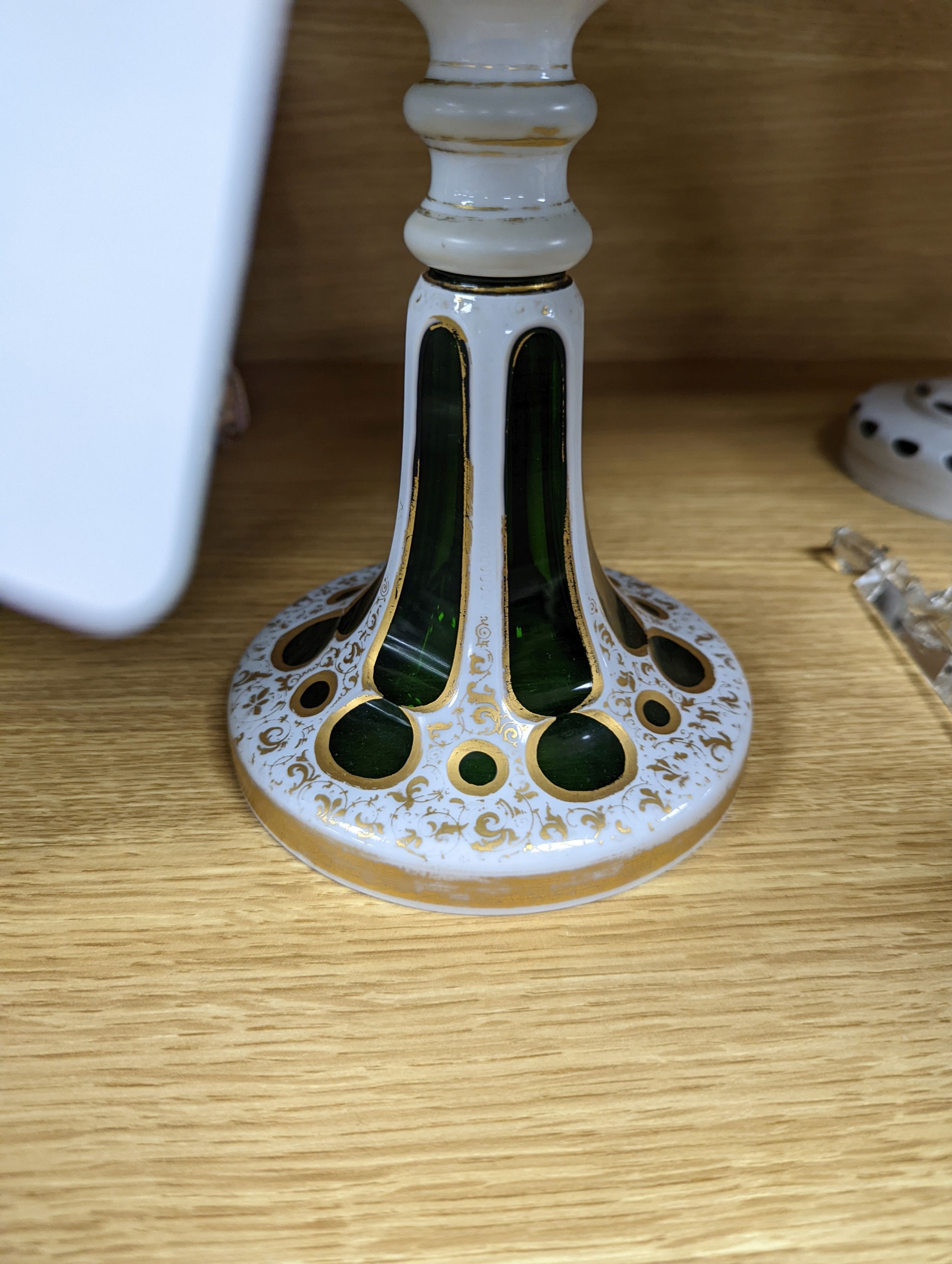 A 19th century overlaid green glass comport, 24cm high, and a similar table lustre